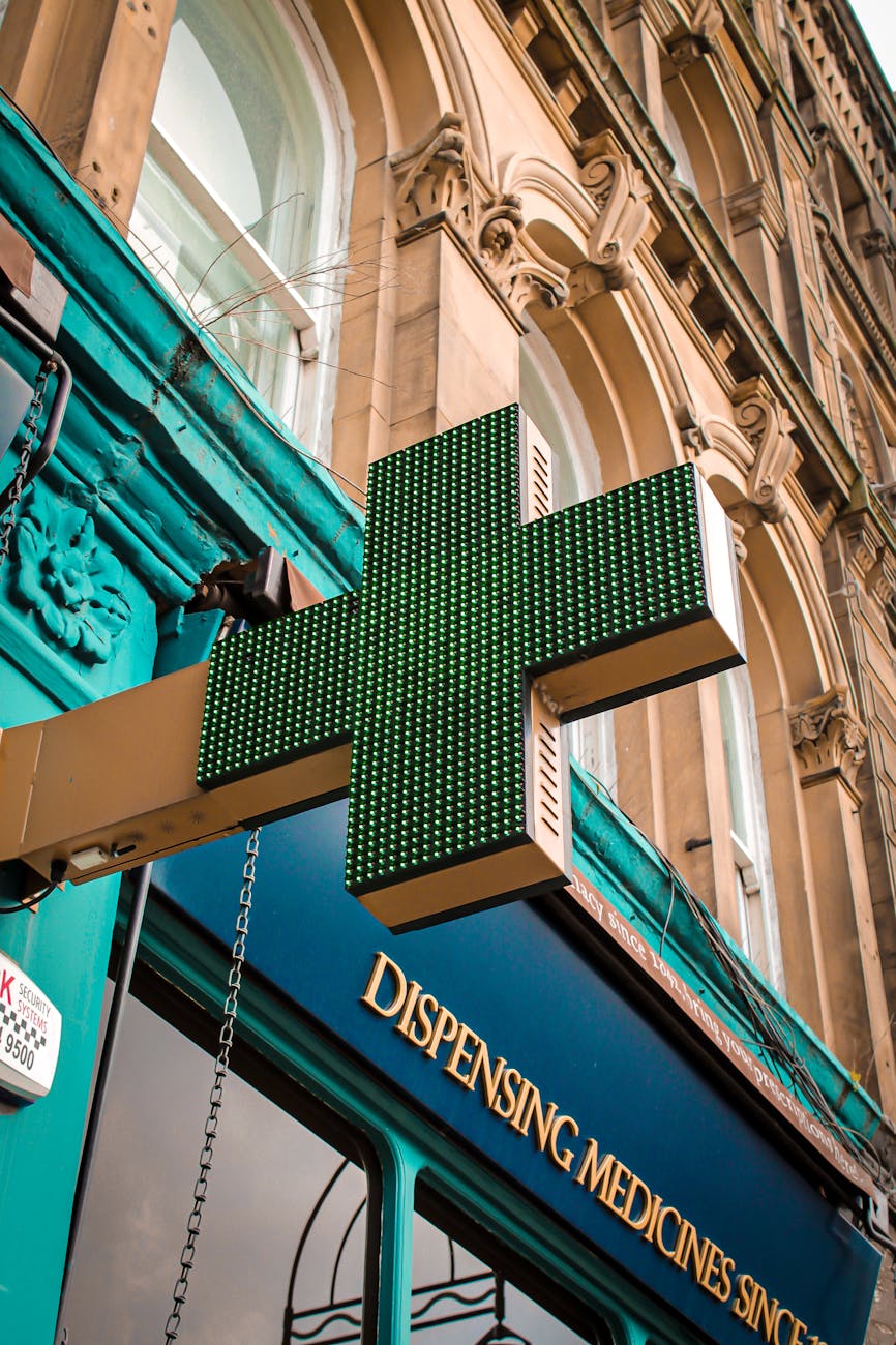 green medical cross outside a pharmacy