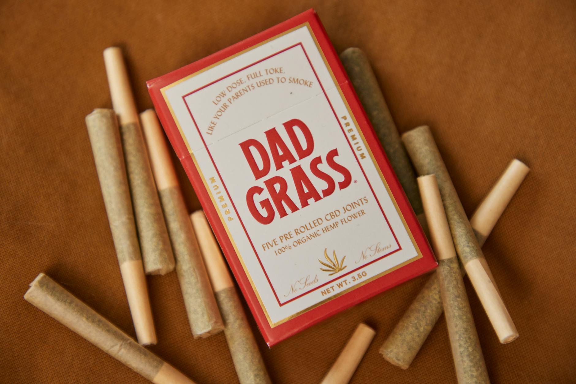 rolled joints on brown surface